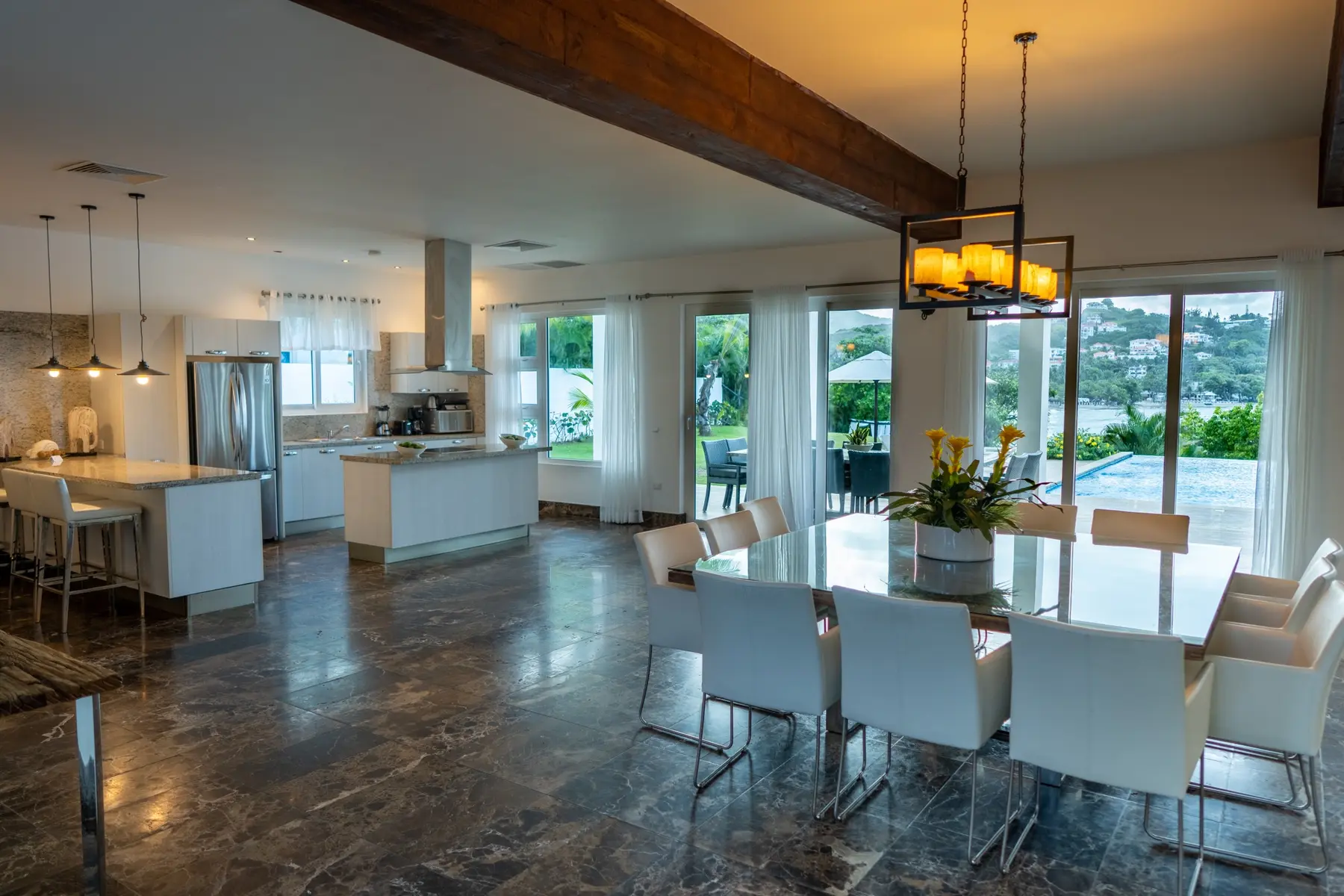 Modern open-plan kitchen and dining room inside The Cliff villa