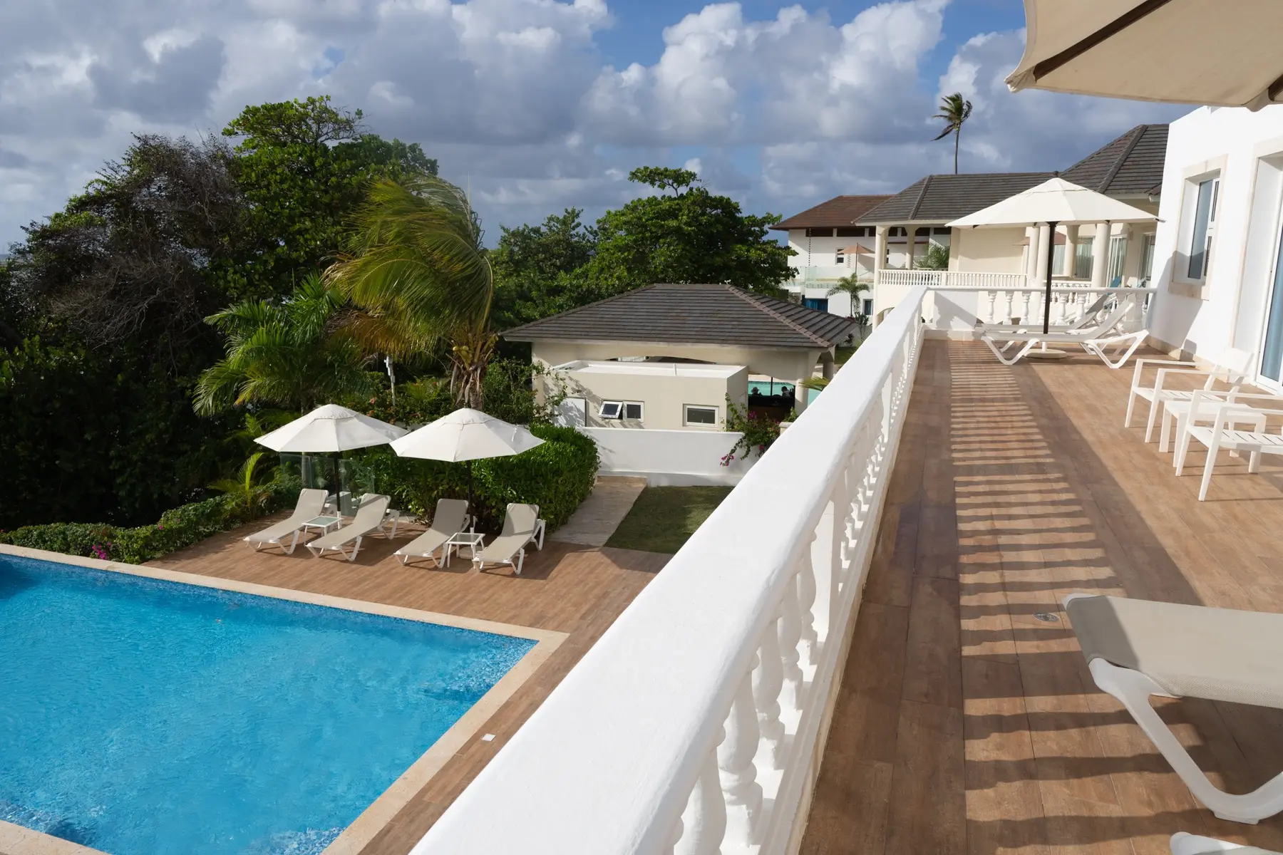 The Cliff villa terrace with private pool, modern architecture and lounge chairs