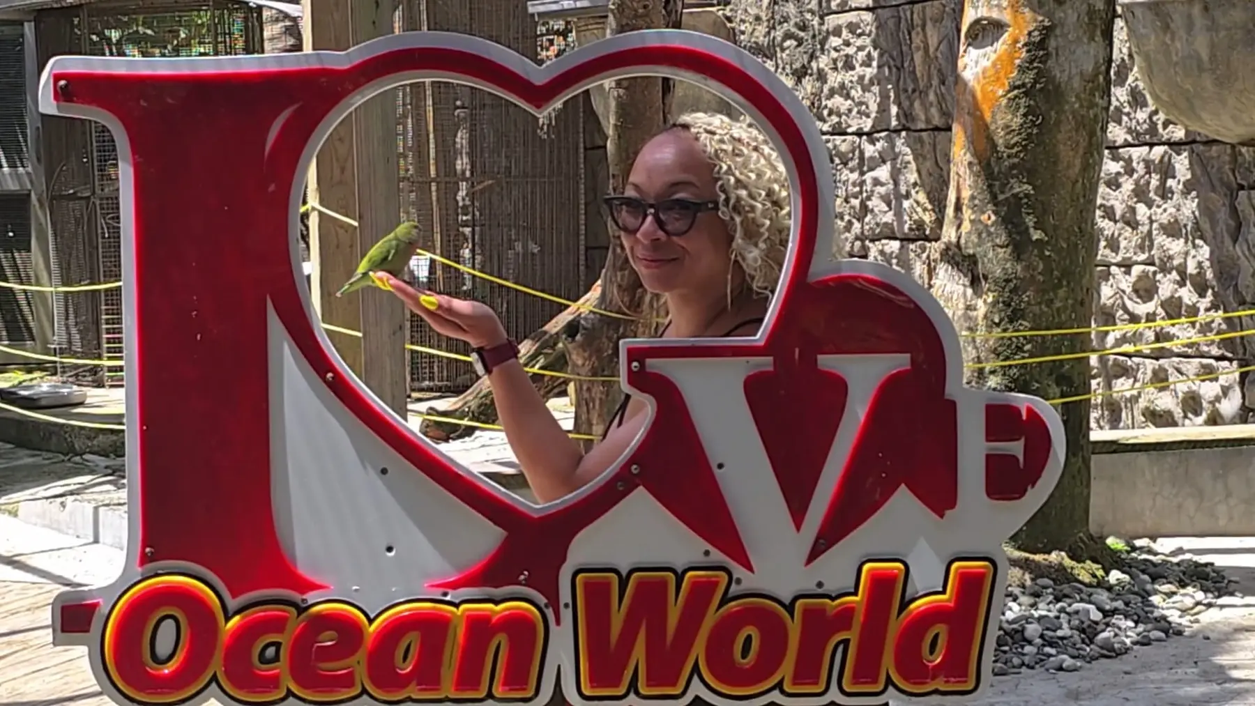 Passport Collective traveler feeding a bird at Ocean World in Puerto Plata