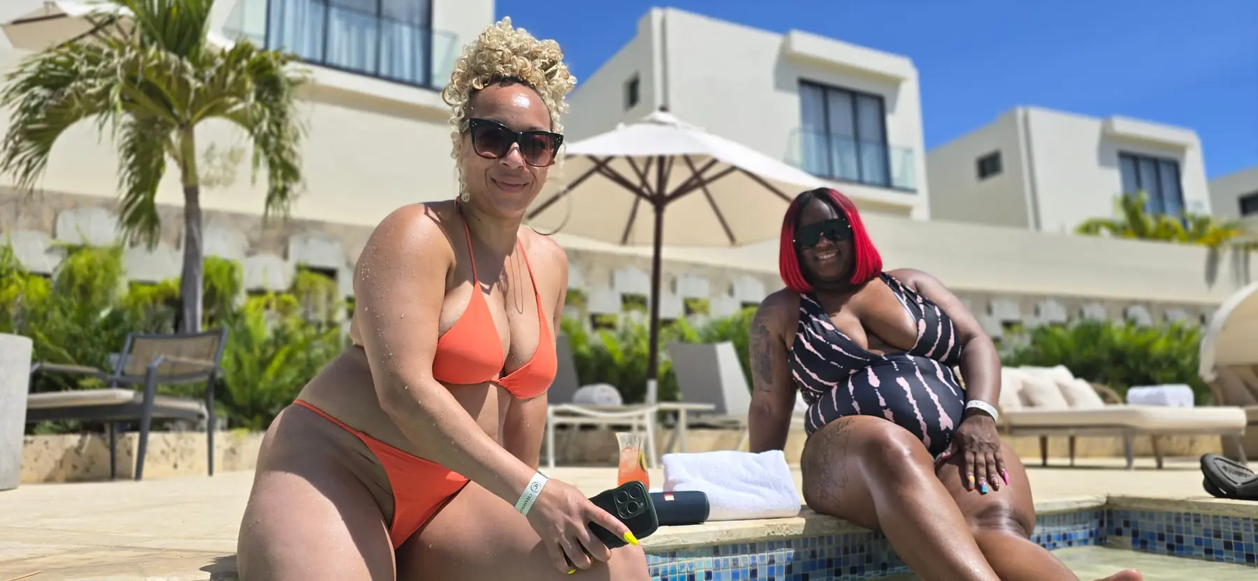 Two Passport Collective travelers relaxing beside a private pool in Puerto Plata